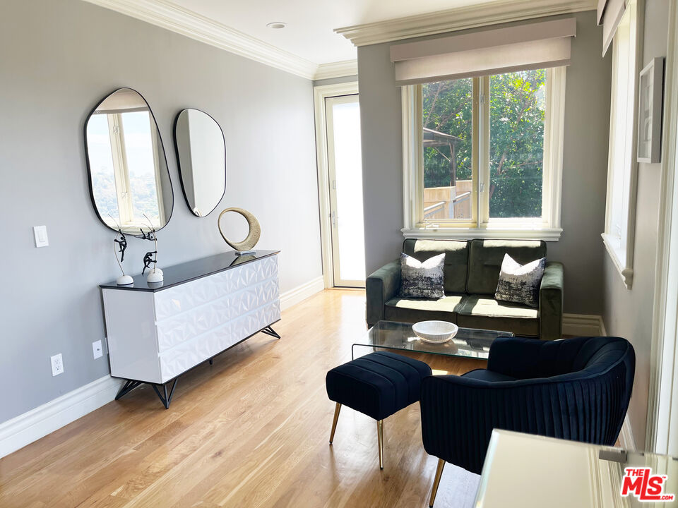 1861 Bel Air Road Los Angeles, CA 90077 - Photo 31 of 44 a living room with furniture a mirror and a window
