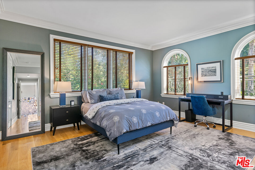 1861 Bel Air Road Los Angeles, CA 90077 - Photo 35 of 44 a bedroom with a bed and wooden floor