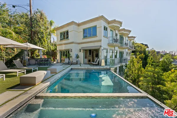 a front view of a house with sitting area
