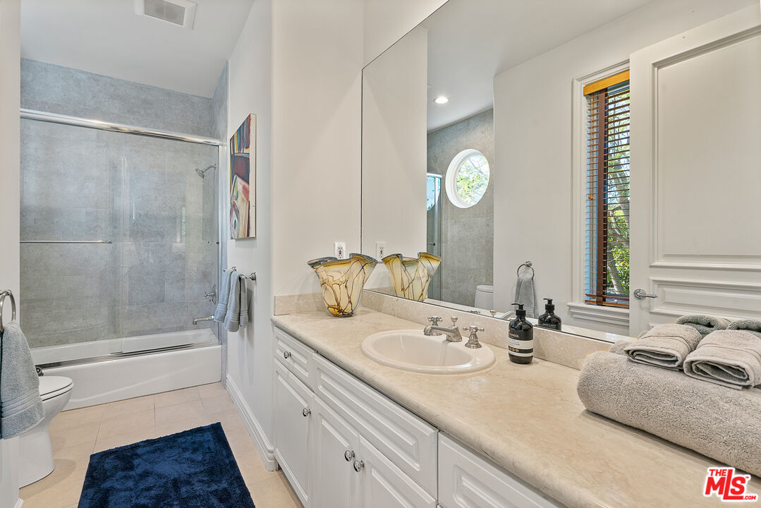 1861 Bel Air Road Los Angeles, CA 90077 - Photo 43 of 44 a bathroom with double vanity sink and a mirror