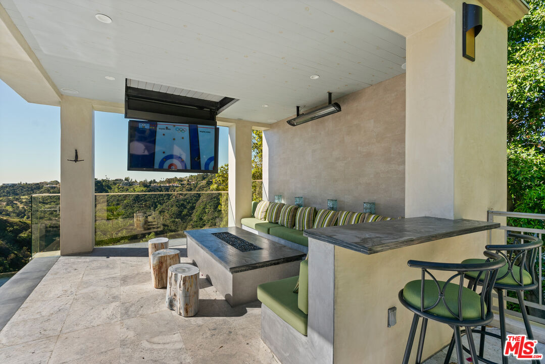 1861 Bel Air Road Los Angeles, CA 90077 - Photo 5 of 44 a table and chairs in front of a house