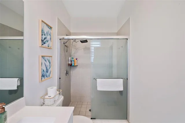 a bathroom with a shower and a sink