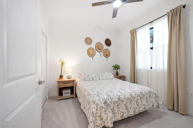 a bedroom with a bed and a chandelier fan