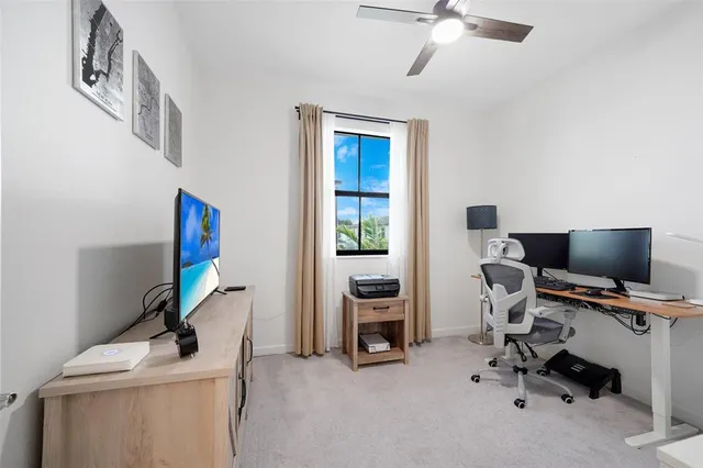a view of a workspace with furniture and a window