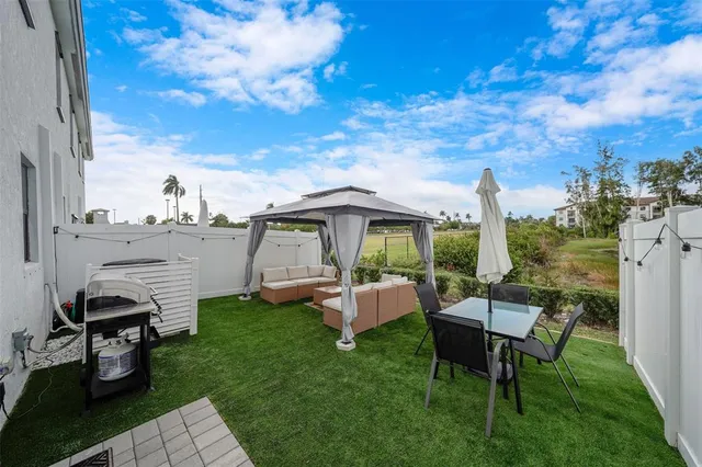 a view of a house with backyard porch and sitting area