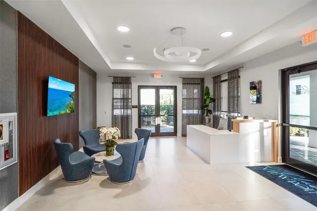 a living room with furniture and large windows