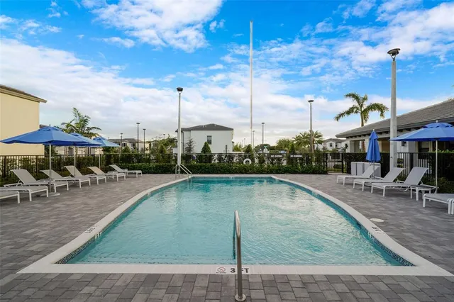 a view of a swimming pool with sitting area