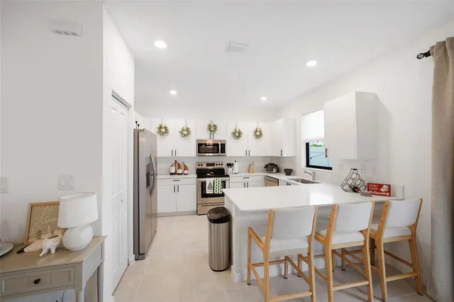 a kitchen with refrigerator and cabinets