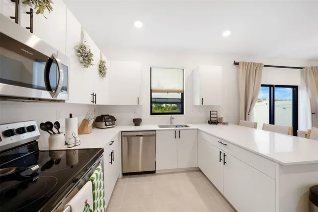 a kitchen with a sink a stove and cabinets