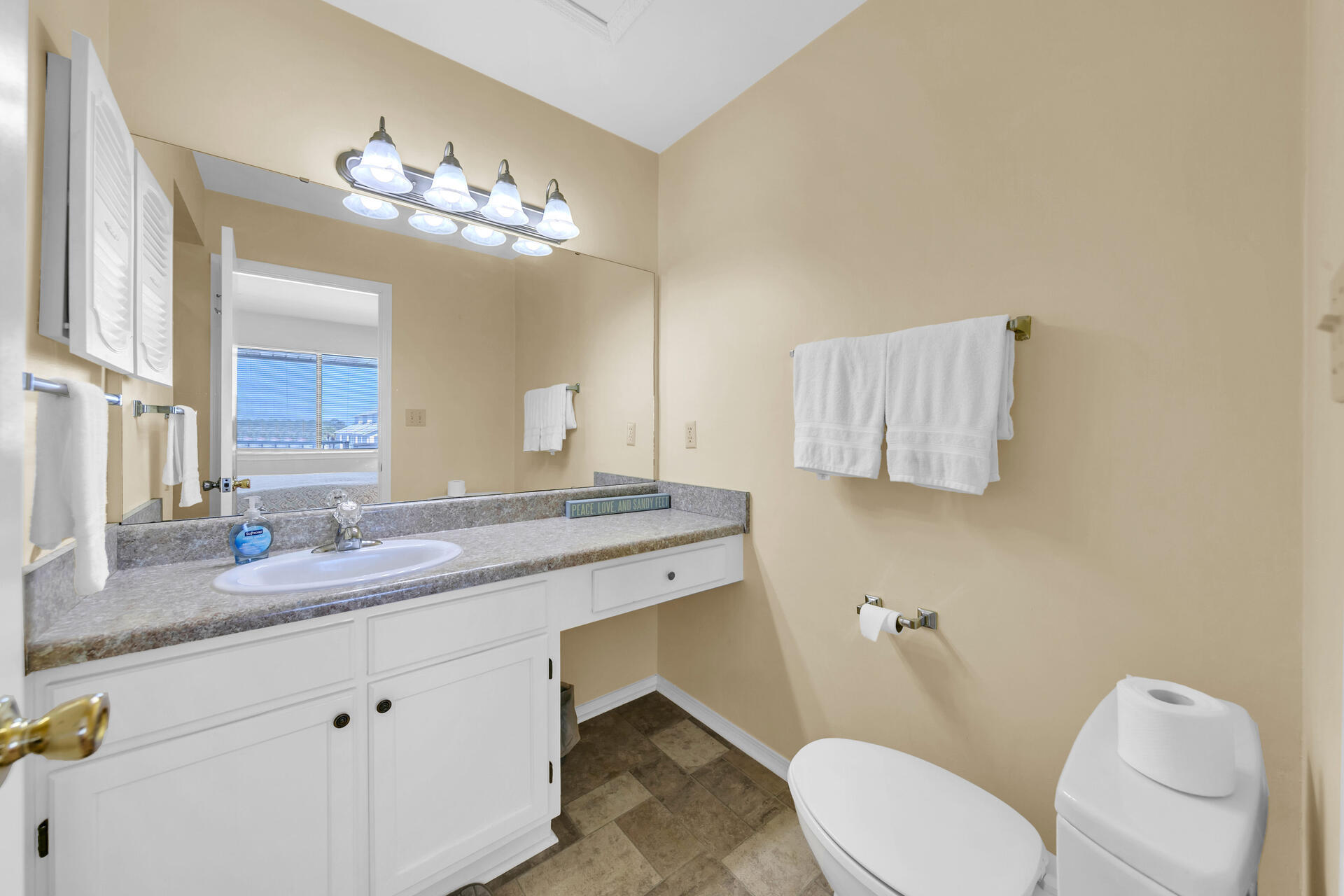 60 Sandprints Drive, Unit C4 Miramar Beach, FL 32550 - Photo 14 of 28 a bathroom with a granite countertop toilet sink and mirror