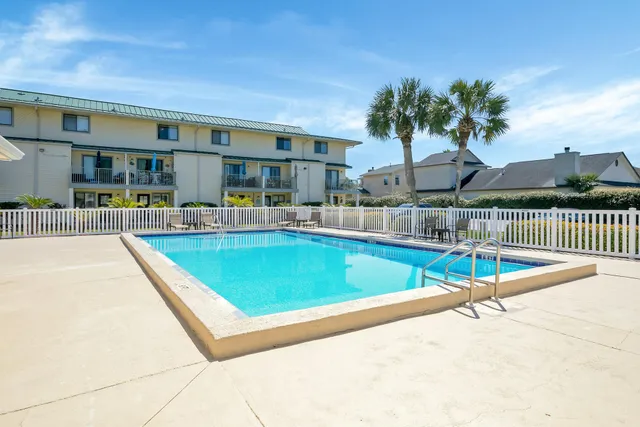 a view of a patio with swimming pool table and chairs