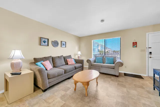 a living room with furniture and a lamp