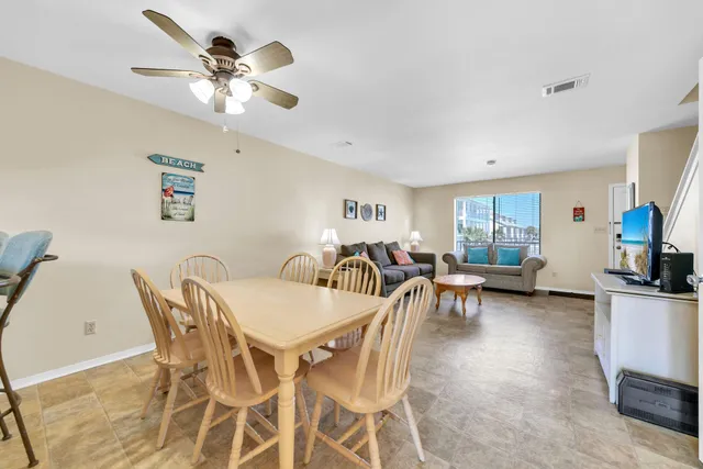 a view of a dining room with furniture and a chandelier