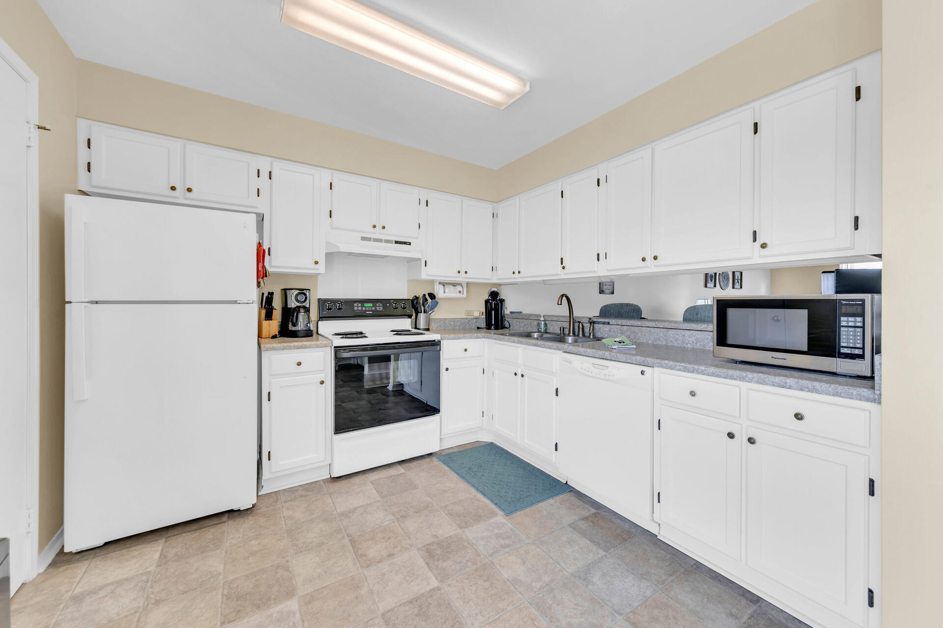 60 Sandprints Drive, Unit C4 Miramar Beach, FL 32550 - Photo 7 of 28 a kitchen with cabinets stainless steel appliances and sink