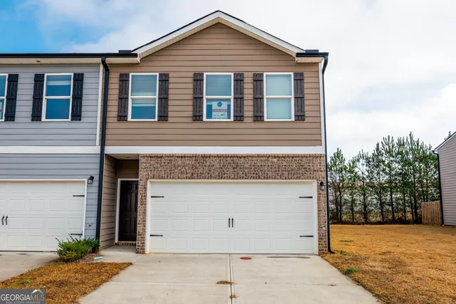 a front view of a house with a yard