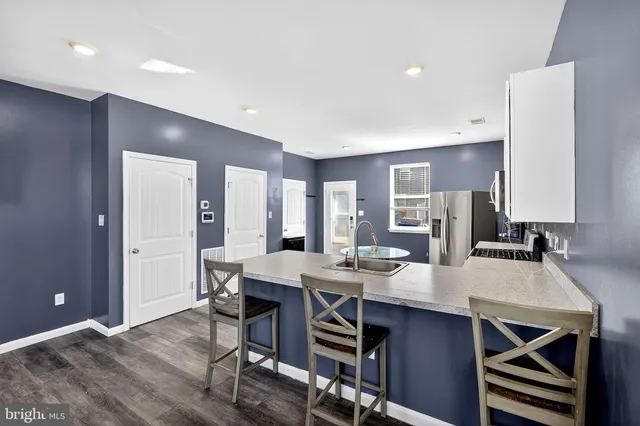 a large kitchen with a table and chairs