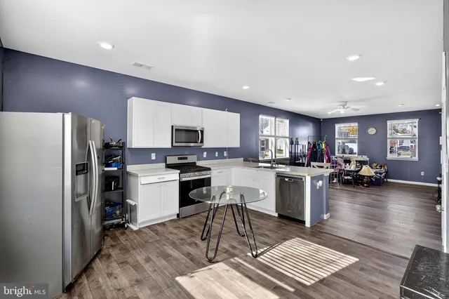a kitchen with sink refrigerator and stove