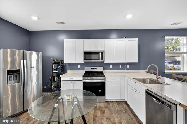 a kitchen with a sink stove and refrigerator