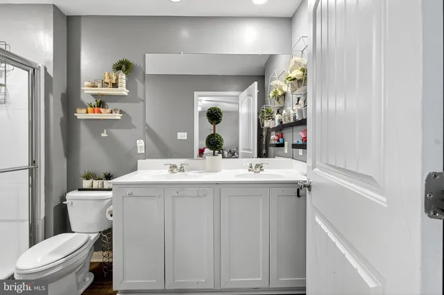 a bathroom with a sink toilet and mirror