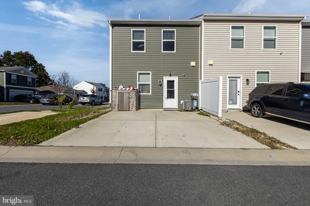 a view of a car park in front of a house