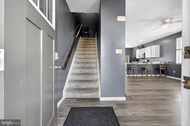 a view of a kitchen with furniture and wooden floor