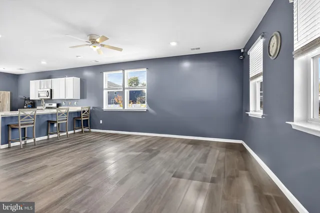 a view of kitchen and window with wooden floor