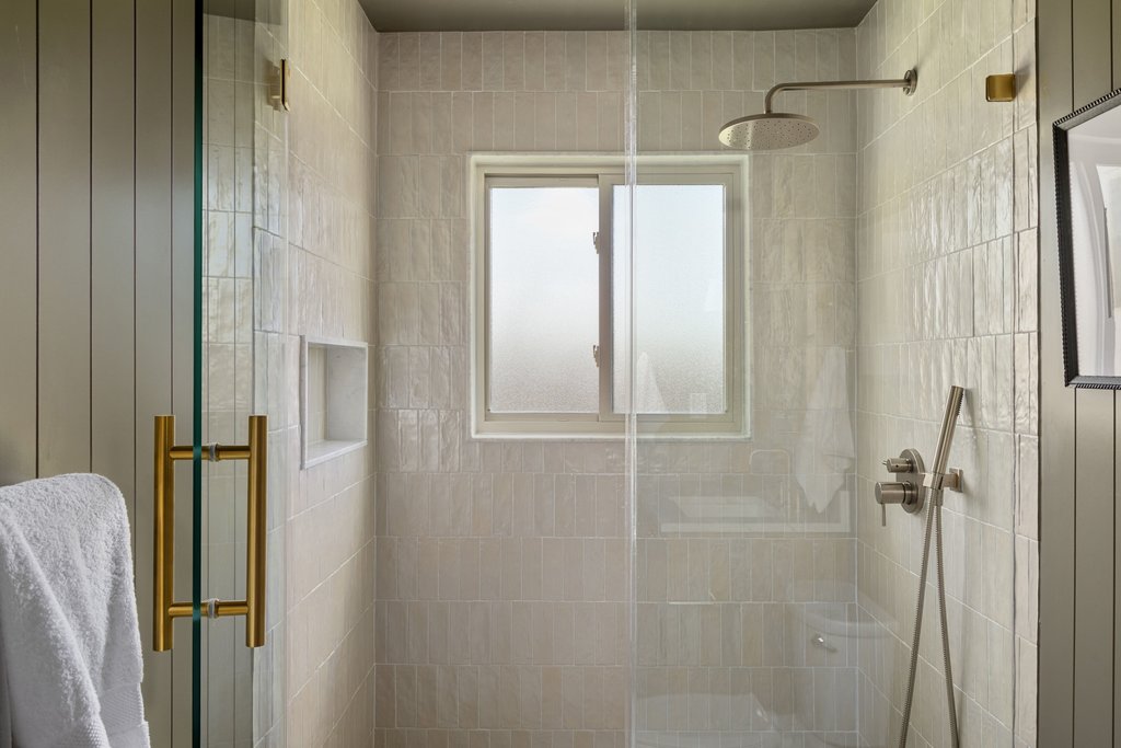 5213 Buffalo Pass Austin, TX 78745 - Photo 16 of 26 The walk-in shower features elevated fixtures and refined material selections.