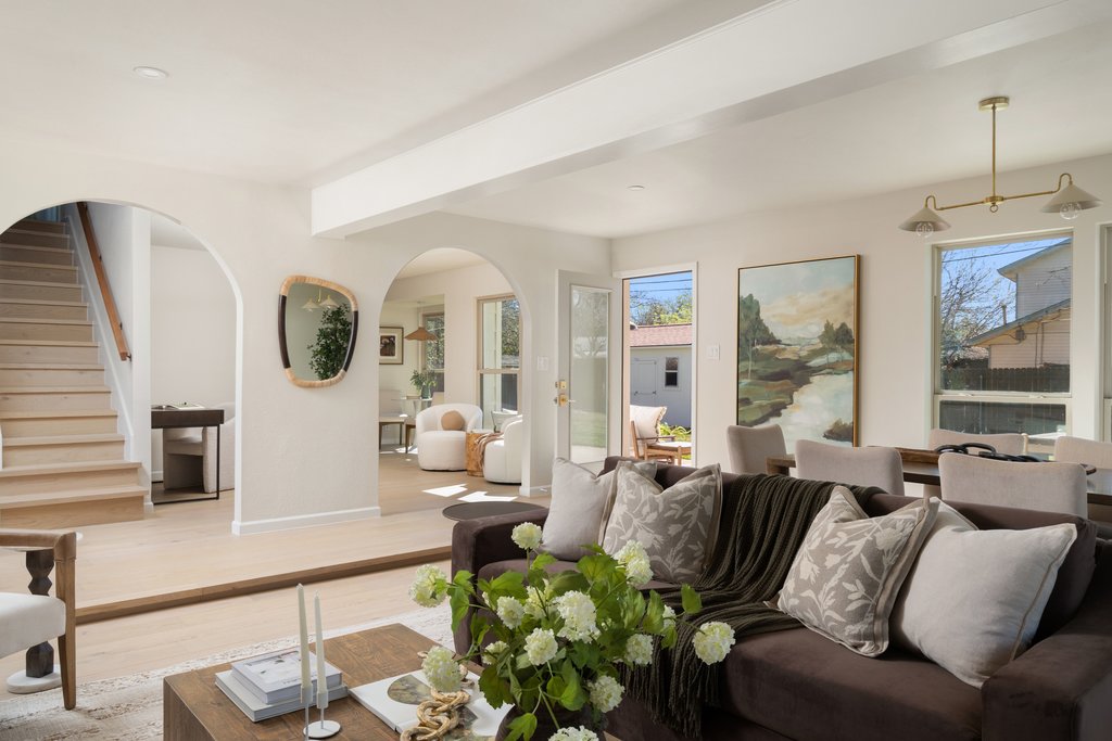 5213 Buffalo Pass Austin, TX 78745 - Photo 4 of 26 The light-filled living room with warm white oak floors and arched doorways are one of the many design features found in this home.
