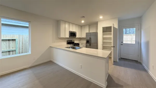 a kitchen with refrigerator and window