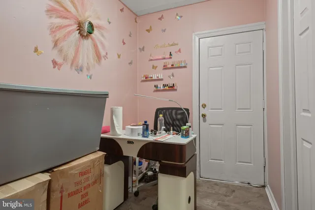 a room with table and white cabinets
