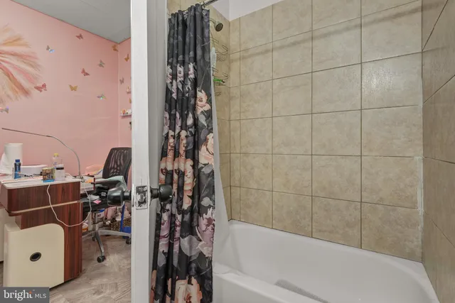 a bathroom with a bathtub and shower