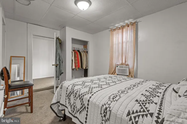 a bedroom with a bed and a television