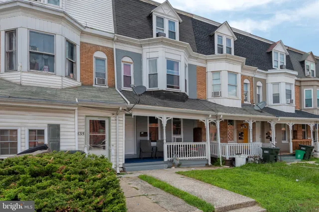 a view of a brick building next to a yard