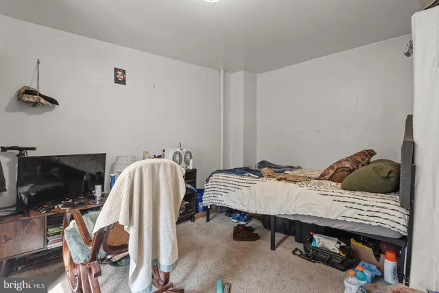 a bedroom with a bed and a tv