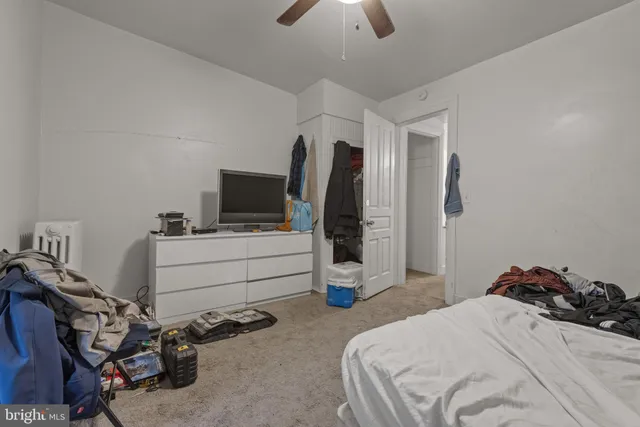 a bedroom with a bed and flat screen tv