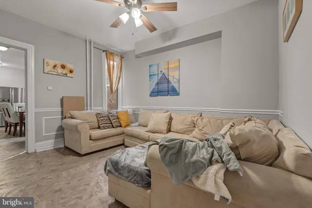a living room with furniture and a chandelier
