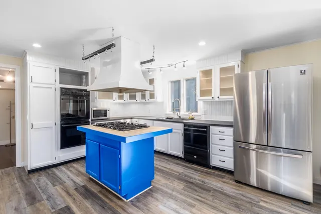 a kitchen with stainless steel appliances granite countertop a stove and a refrigerator
