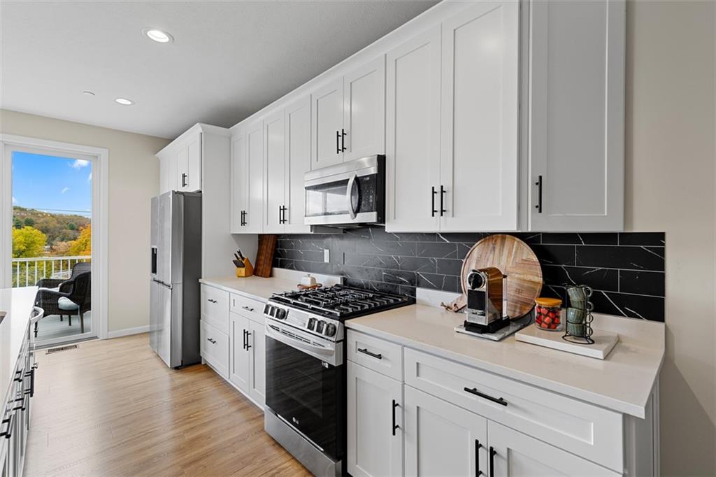 403 Walnut Court Pittsburgh, PA 15237 - Photo 15 of 42 a kitchen with stainless steel appliances granite countertop a stove a refrigerator and a white cabinets