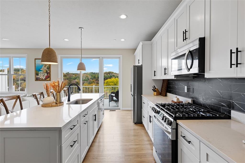 403 Walnut Court Pittsburgh, PA 15237 - Photo 16 of 42 a kitchen with stainless steel appliances a stove a sink a refrigerator a center island and windows