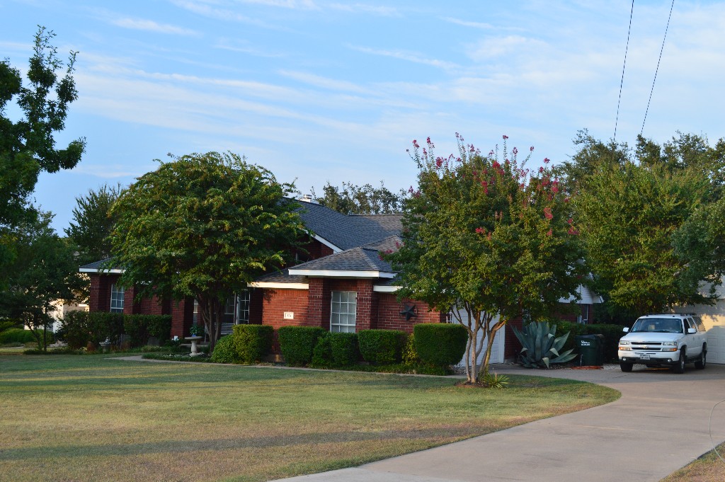 124 D B Wood Road Georgetown, TX 78628 - Photo 1 of 1 Beautifully landscaped home with large front lawn, 2 car attached, 2 car detached garage and RV parking!