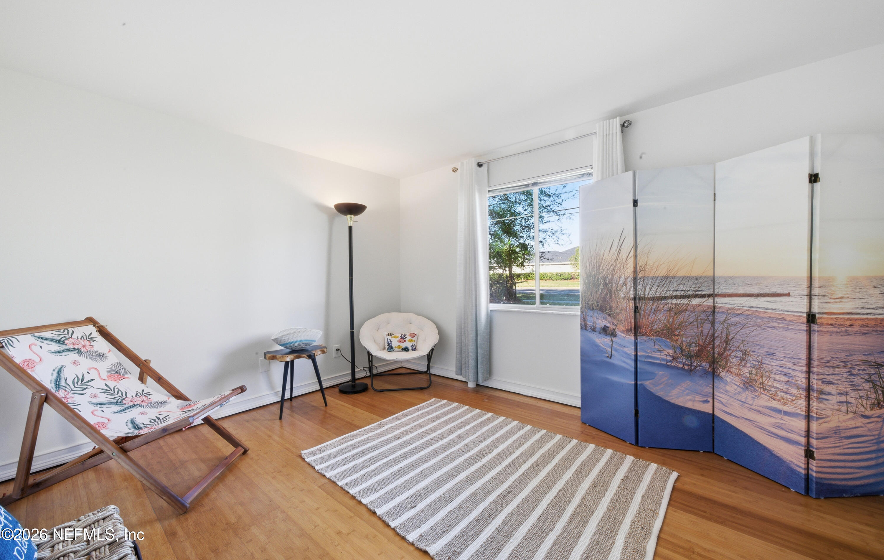 147 Knight Boxx Road Middleburg, FL 32068 - Photo 18 of 30 a bedroom with a bed and wooden floor