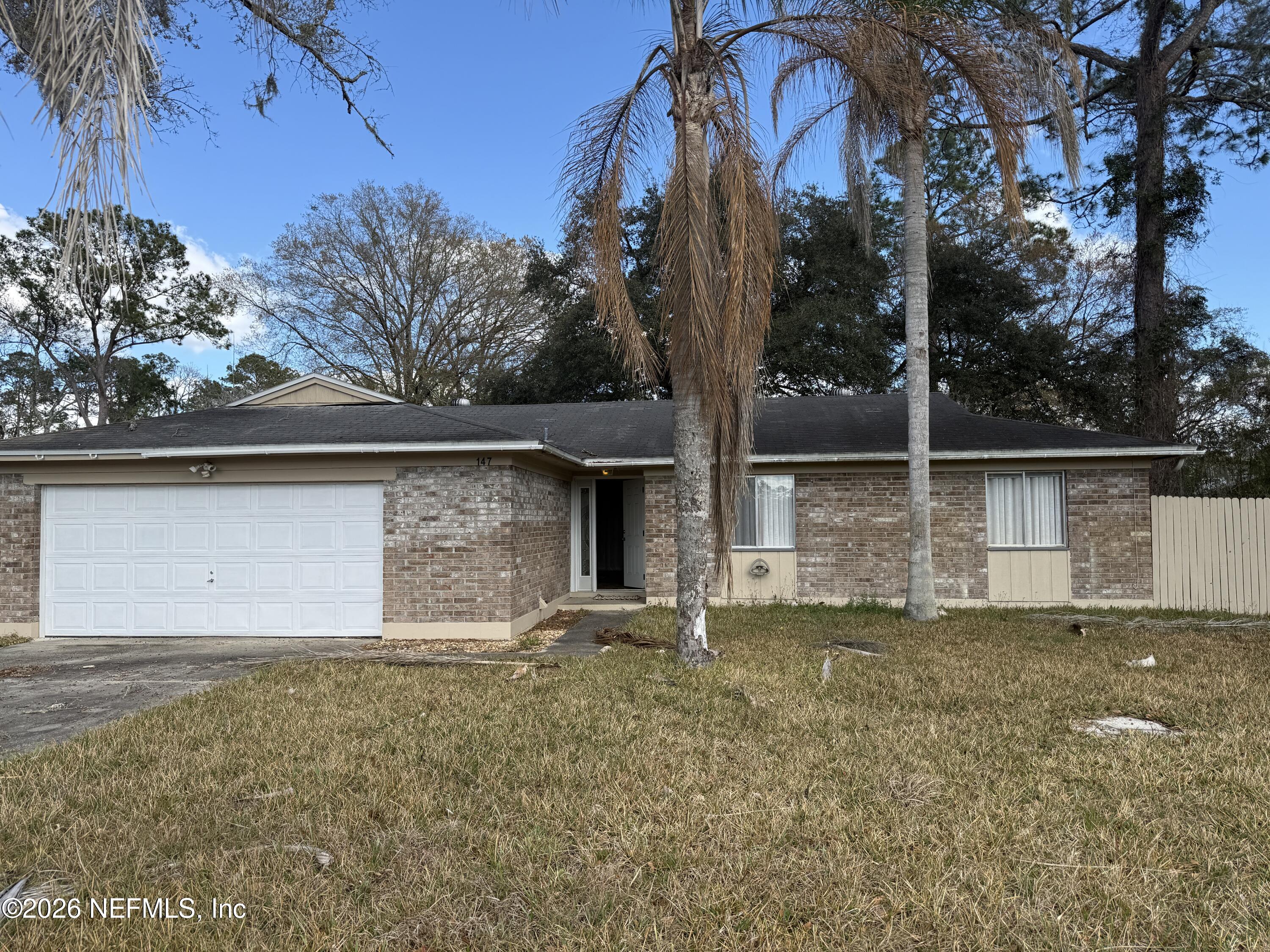 147 Knight Boxx Road Middleburg, FL 32068 - Photo 30 of 30 a front view of a house with a yard and garage