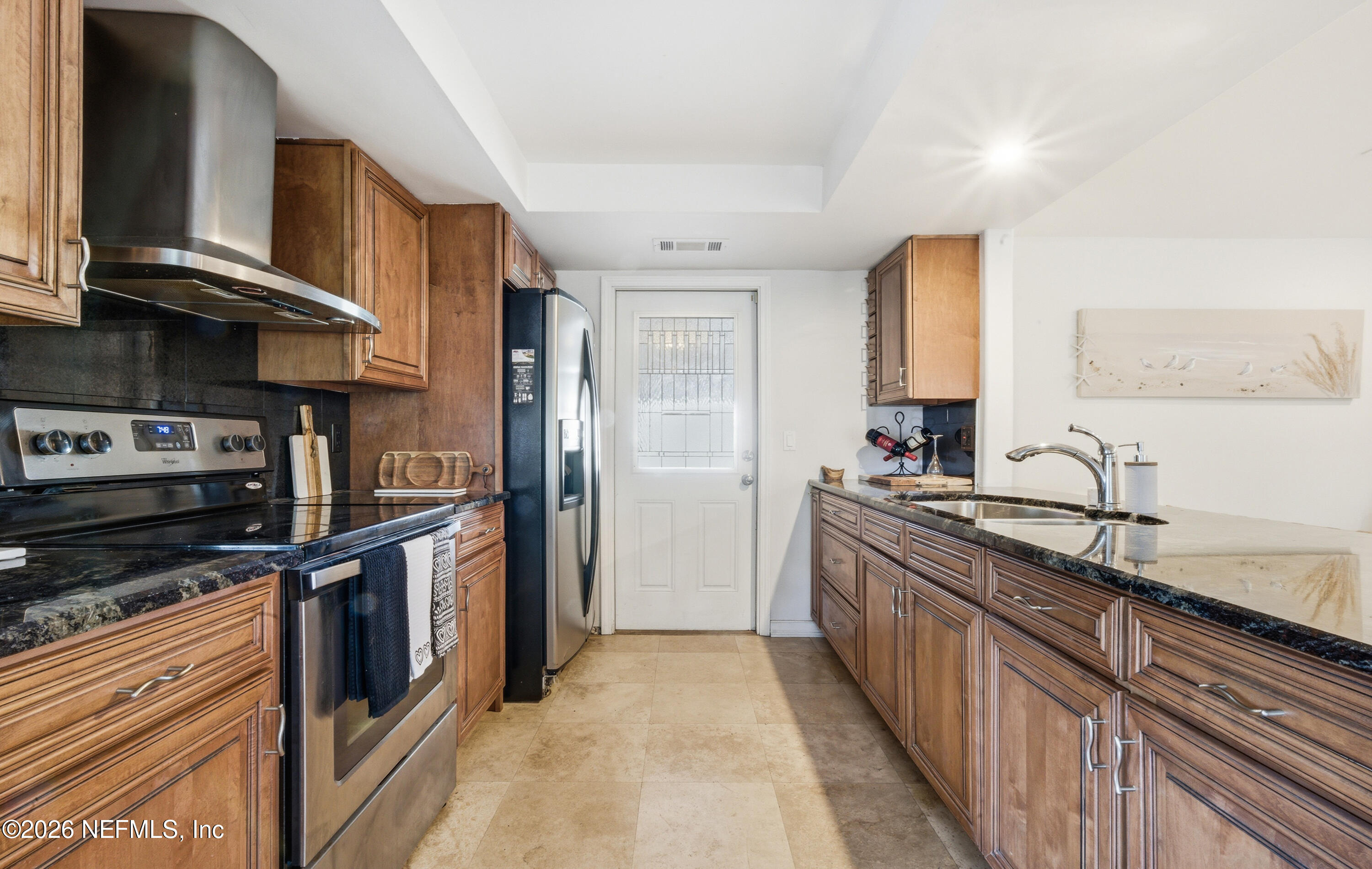 147 Knight Boxx Road Middleburg, FL 32068 - Photo 3 of 30 a kitchen with stainless steel appliances granite countertop a stove a sink and a refrigerator