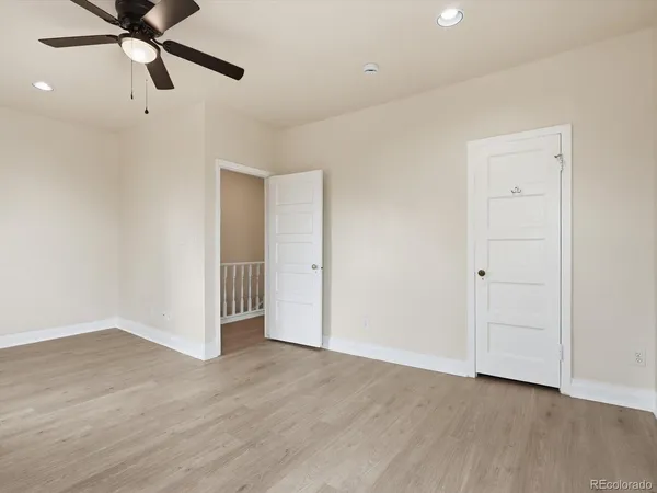 a view of an empty room with wooden floor