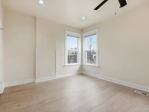 an empty room with a empty space and windows