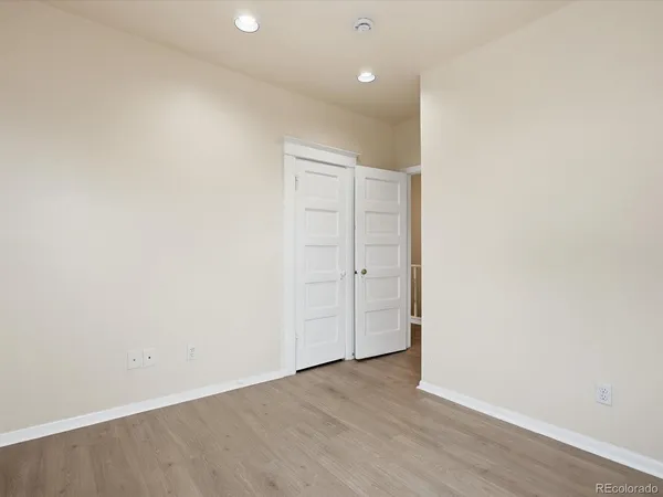 an empty room with wooden floor