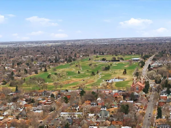 an aerial view of a houses with a yard