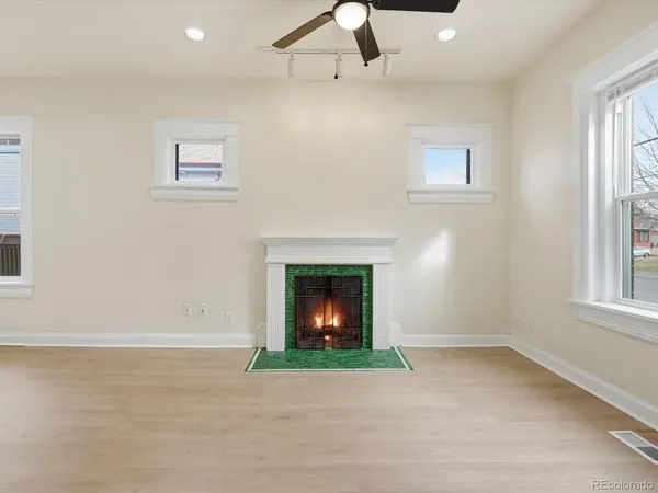 a view of an empty room with window and fireplace