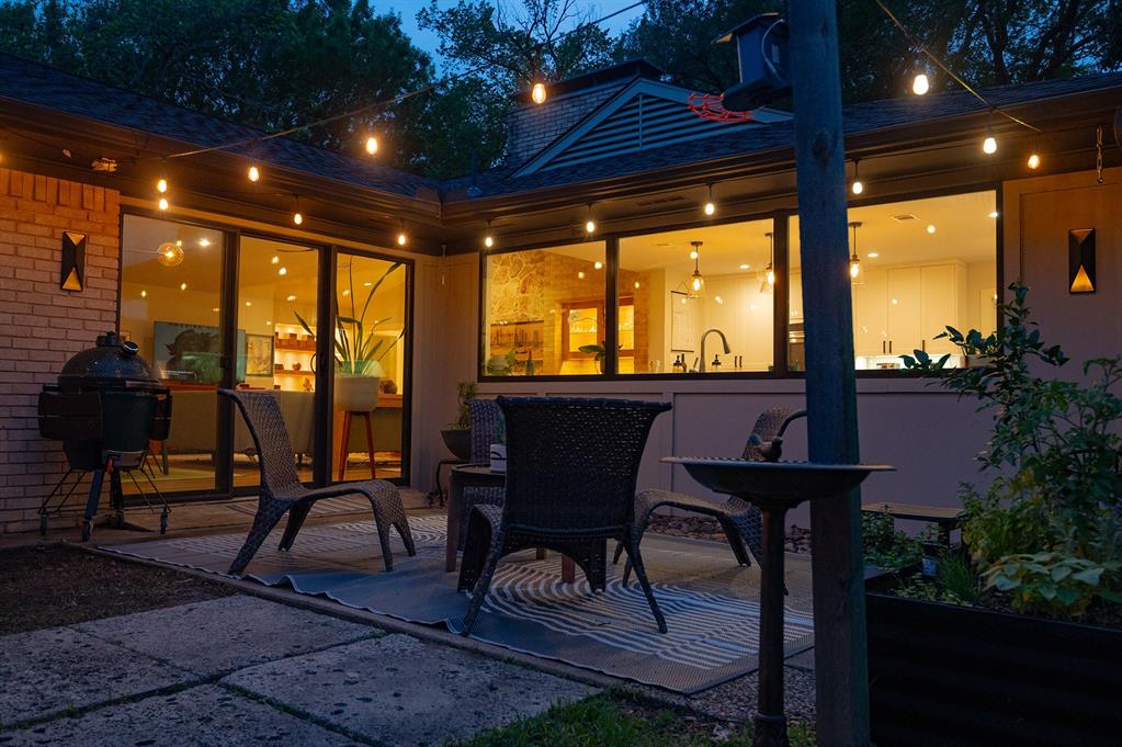 11406 Hillcrest Road Dallas, TX 75230 - Photo 1 of 1 1st outdoor living space with tons of grass and beautiful sitting area looking back at the house.