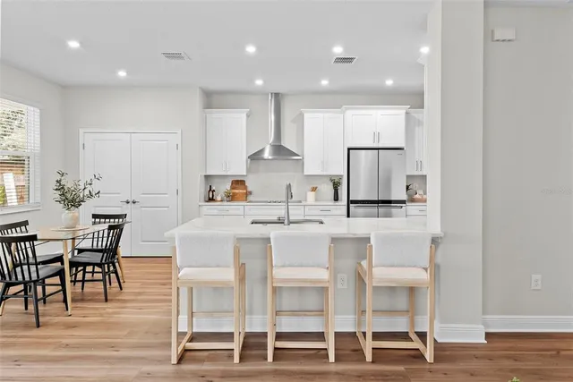 a kitchen with kitchen island cabinets and chairs in it